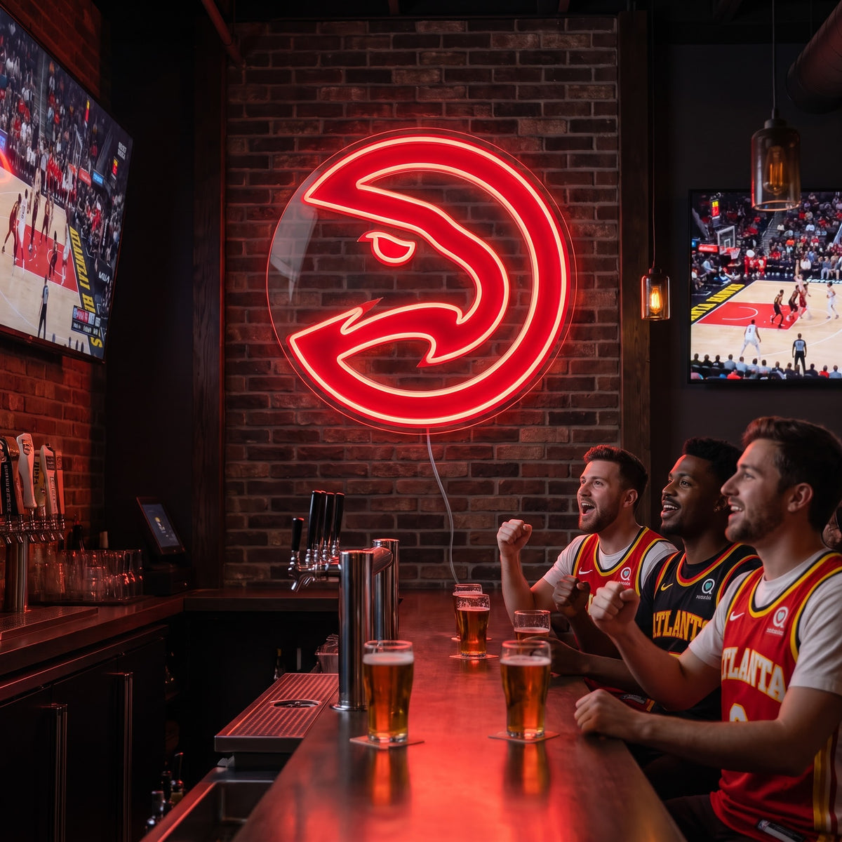 Atlanta Hawks LED neon sign on a brick wall above three fans cheering at a sports bar with basketball on TV