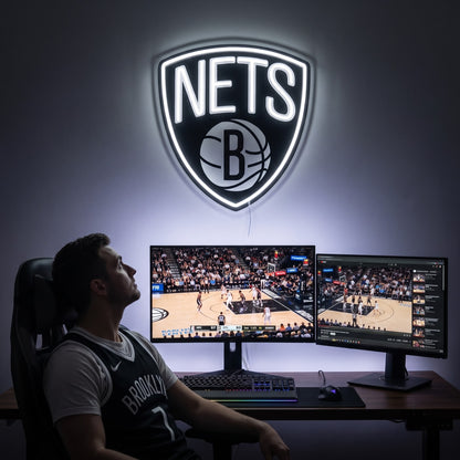 Brooklyn Nets LED neon sign above a gaming setup with a fan watching basketball