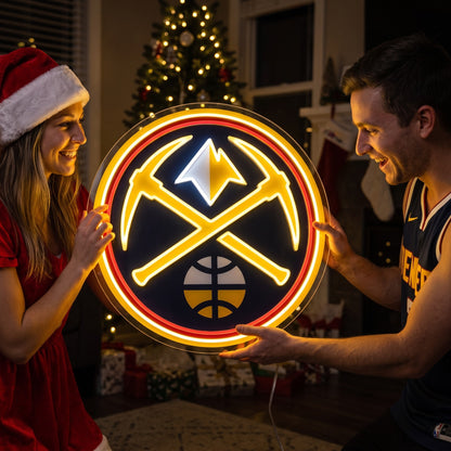 Couple exchanging a Denver Nuggets LED neon sign as a Christmas gift by the tree