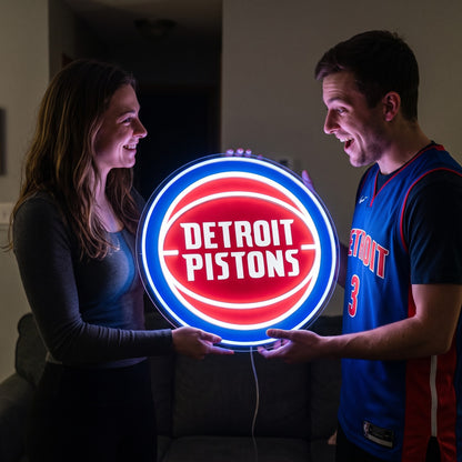 Woman surprising a basketball fan with a glowing Detroit Pistons LED neon sign gift