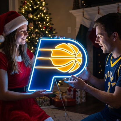 Couple exchanging an Indiana Pacers LED neon sign as a Christmas gift by the tree