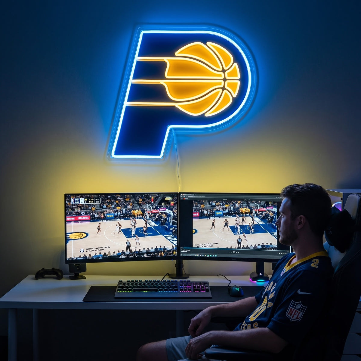 Indiana Pacers LED neon sign above a gaming setup with a fan watching basketball