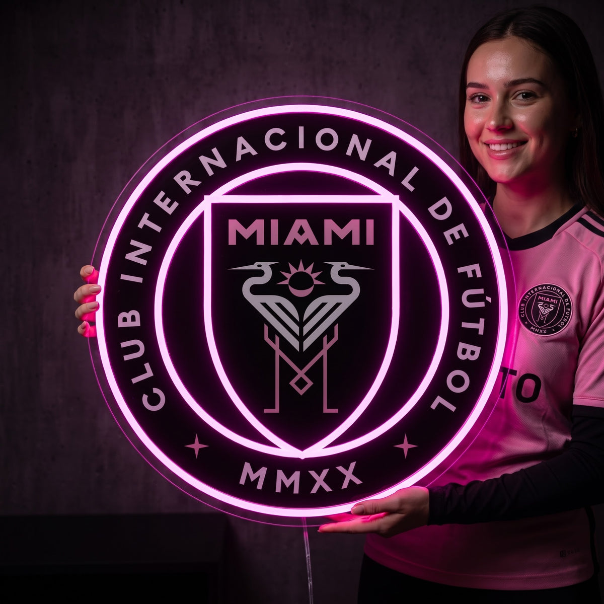 Woman holding a glowing Inter Miami CF LED neon sign