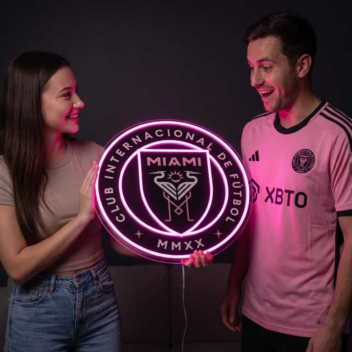 Woman surprising a soccer fan with a glowing Inter Miami CF LED neon sign gift