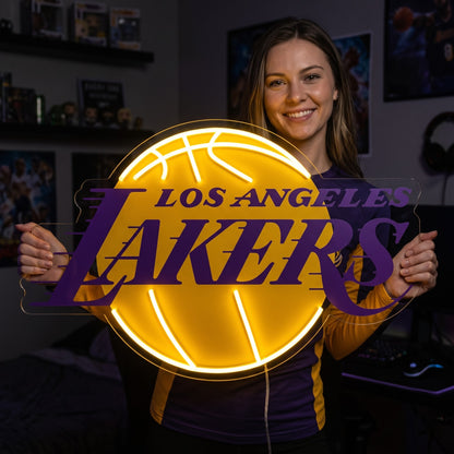 Woman holding a glowing Los Angeles Lakers LED neon sign