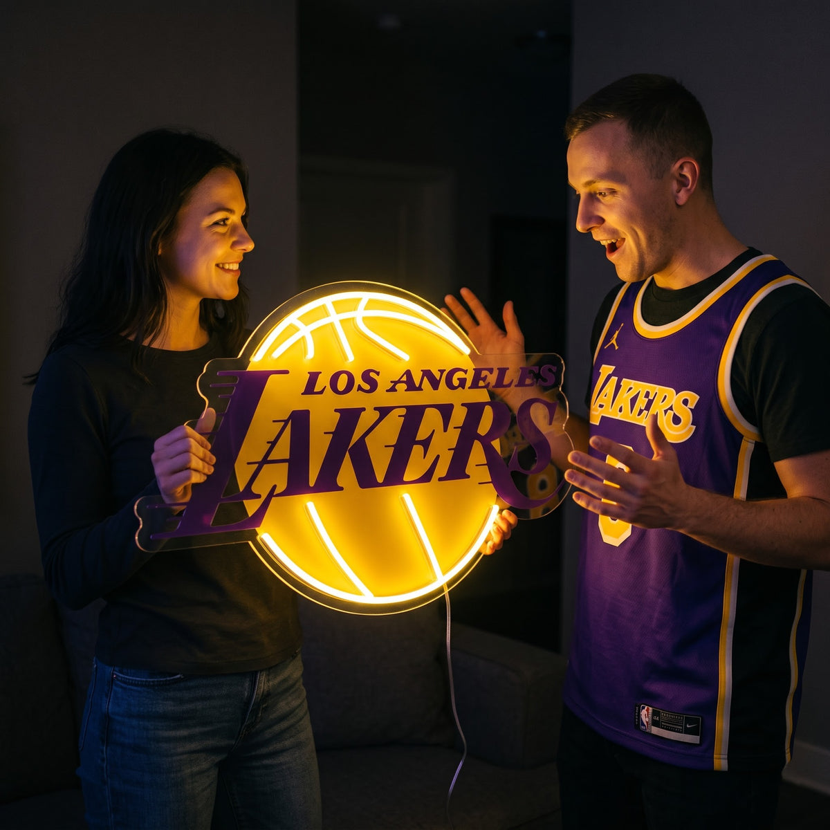 Woman surprising a basketball fan with a glowing Los Angeles Lakers LED neon sign gift
