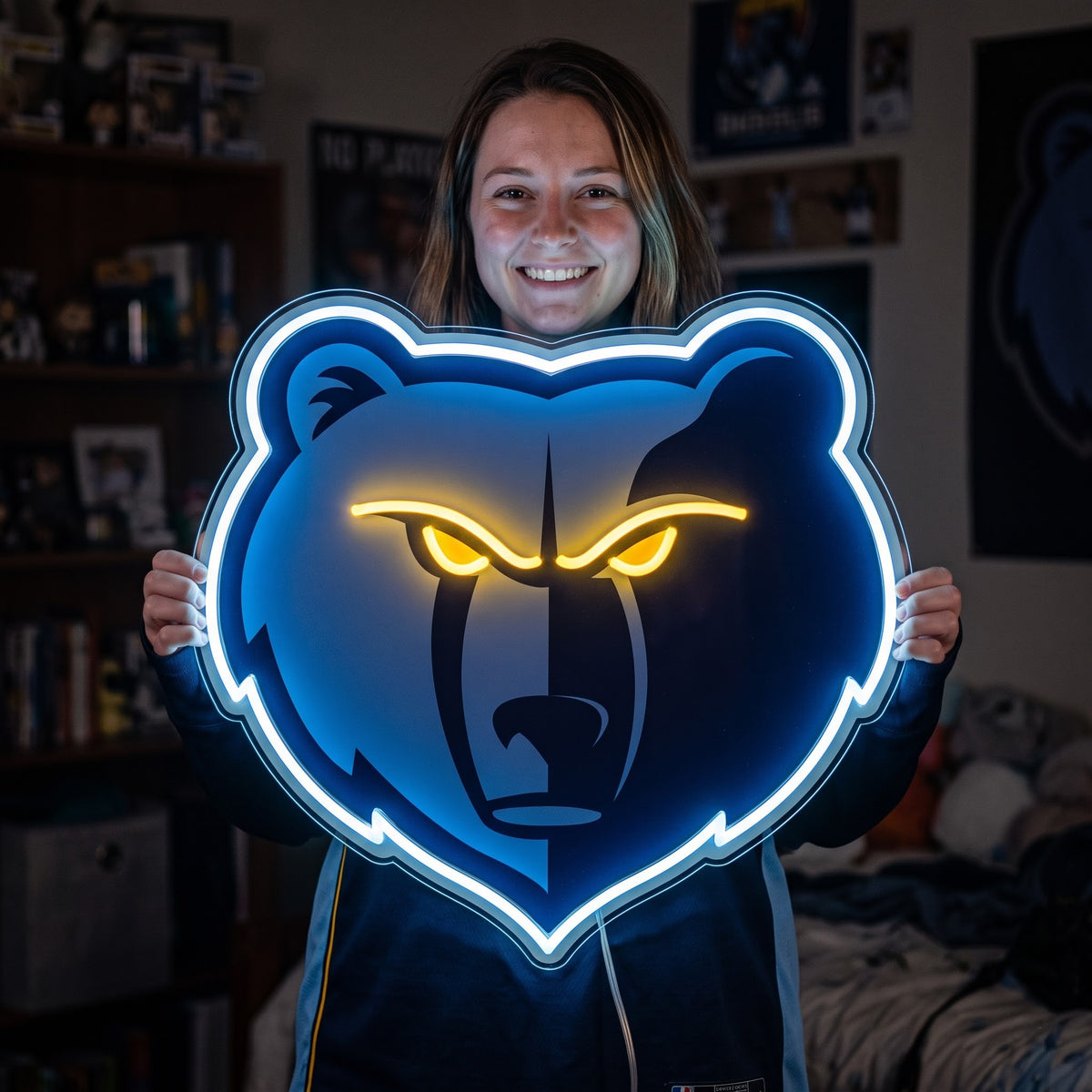 Woman holding a glowing Memphis Grizzlies LED neon sign