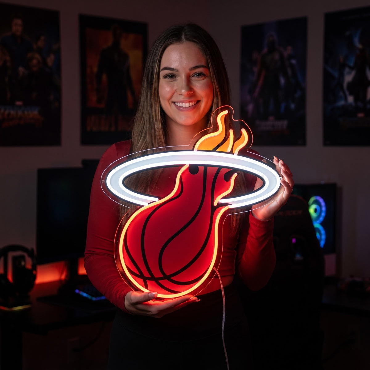 Woman holding a Miami Heat LED neon sign with a red basketball, white hoop and orange flames