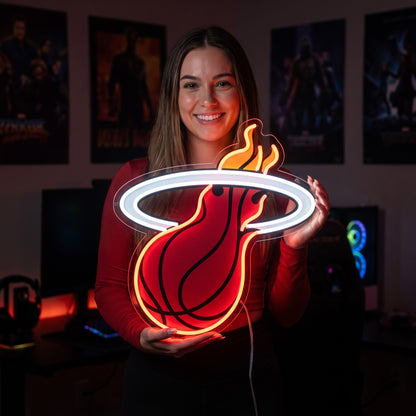 Woman holding a Miami Heat LED neon sign with a red basketball, white hoop and orange flames