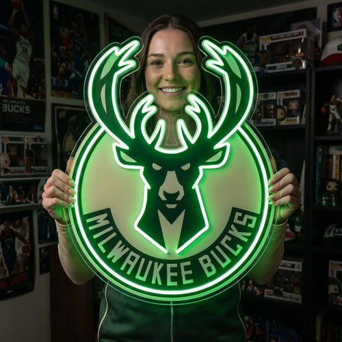 Milwaukee Bucks LED neon sign - A smiling woman holds a large green Milwaukee Bucks deer logo neon sign in a fan room.