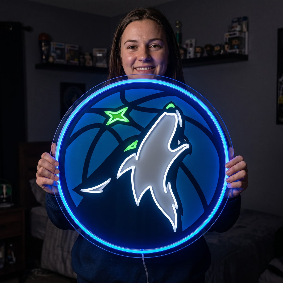 Woman holding a glowing Minnesota Timberwolves LED neon sign