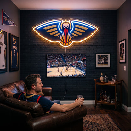 New Orleans Pelicans LED neon sign glowing above the TV in a basketball man cave