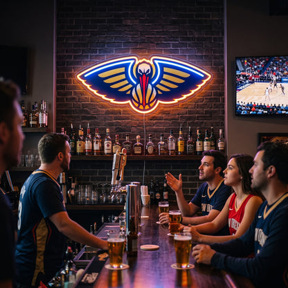 New Orleans Pelicans LED neon sign on a brick wall in a sports bar with fans watching the game