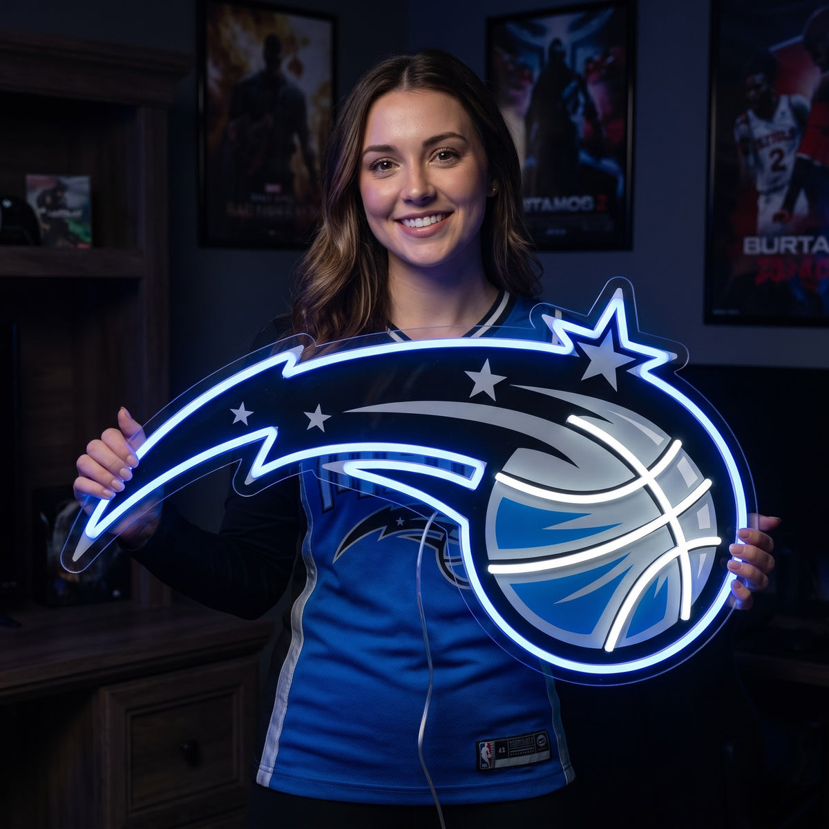 Woman holding a glowing Orlando Magic LED neon sign