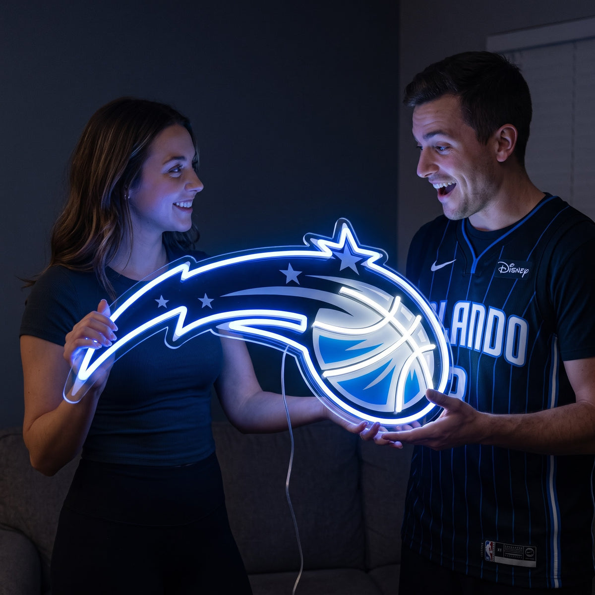 Woman surprising a basketball fan with a glowing Orlando Magic LED neon sign gift