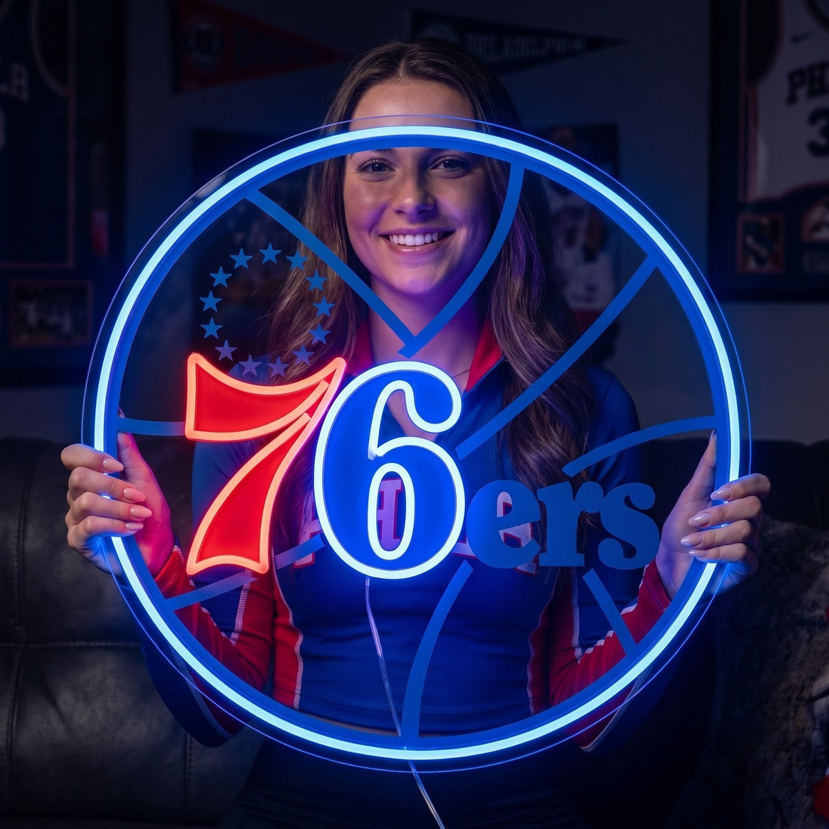 Woman holding a circular Philadelphia 76ers LED neon sign with a bright blue border and red and white logo details