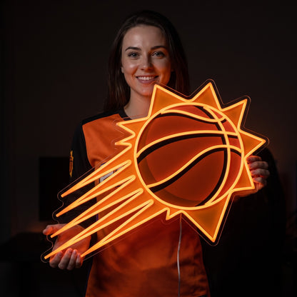 Woman in a Phoenix Suns jersey holding a Phoenix Suns LED neon sign