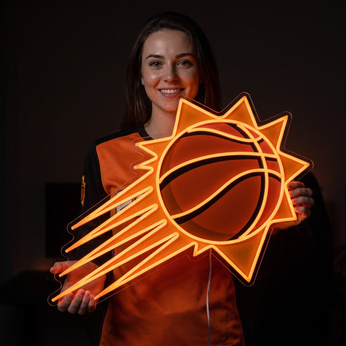 Woman in a Phoenix Suns jersey holding a Phoenix Suns LED neon sign