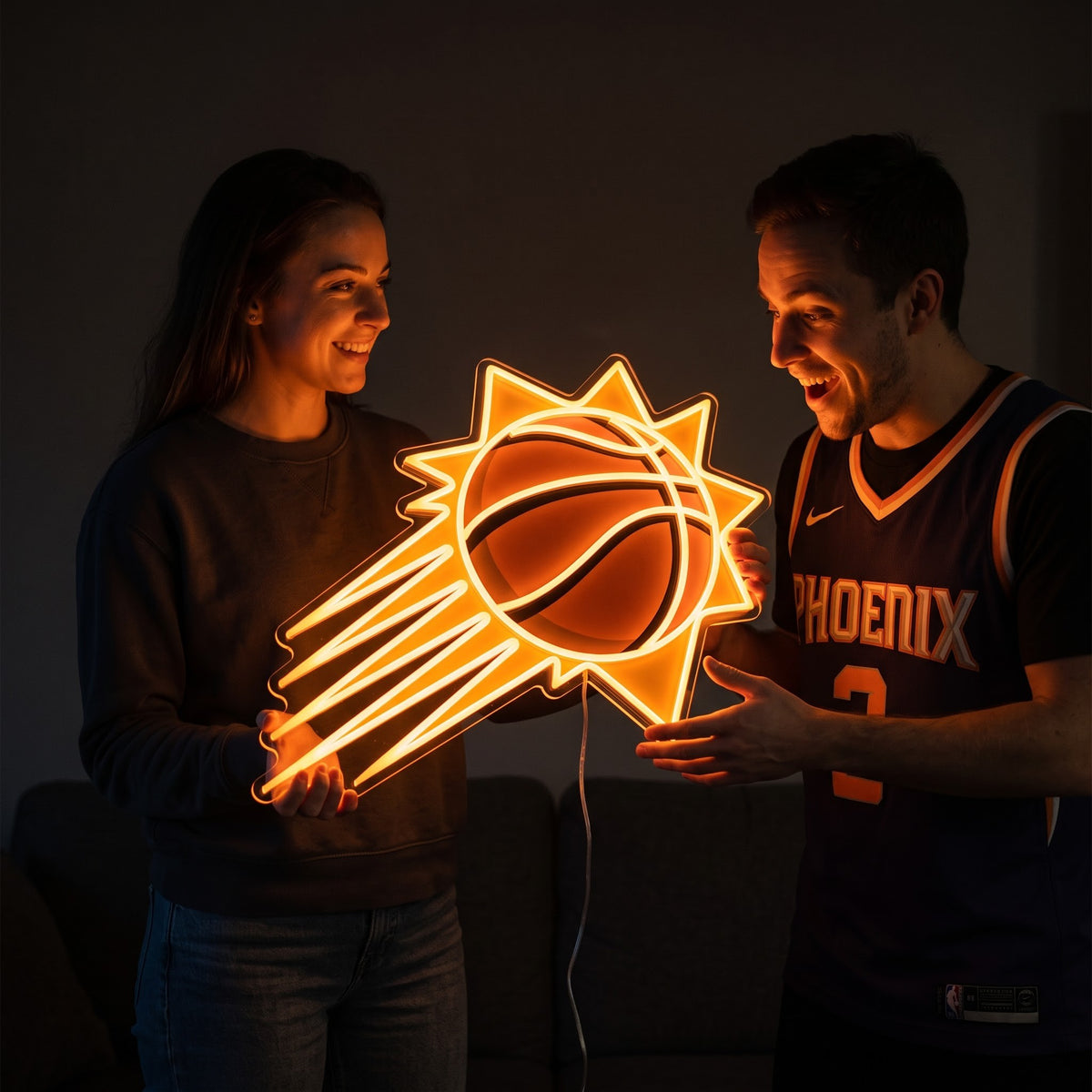 Woman surprising a basketball fan with a glowing Phoenix Suns LED neon sign gift