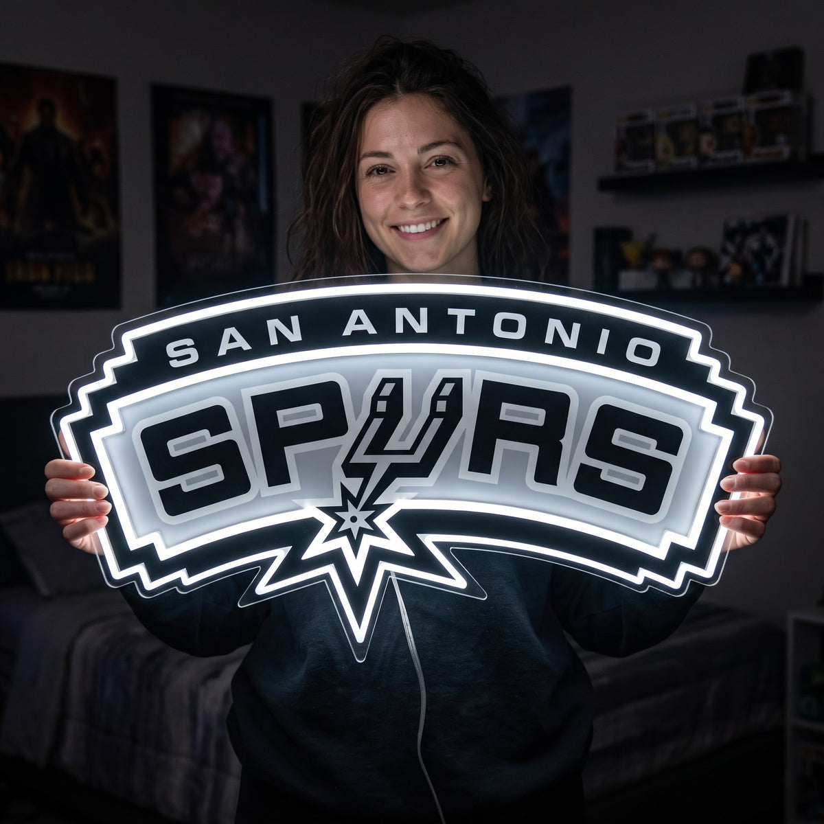 Woman holding a glowing San Antonio Spurs LED neon sign