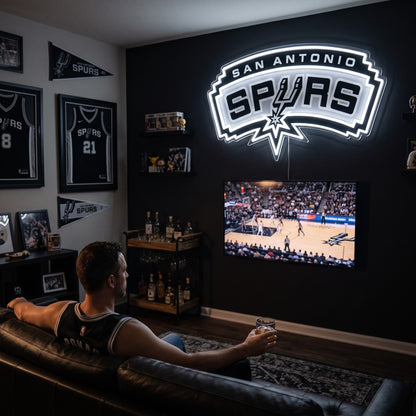 San Antonio Spurs LED neon sign glowing above the TV in a basketball man cave