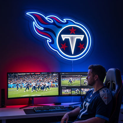 Tennessee Titans flame logo LED neon sign mounted above a dual-monitor gaming desk.