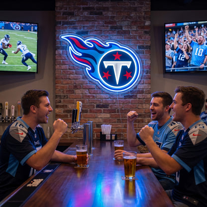 Tennessee Titans flame logo LED neon sign on a brick wall above three fans at a sports bar.
