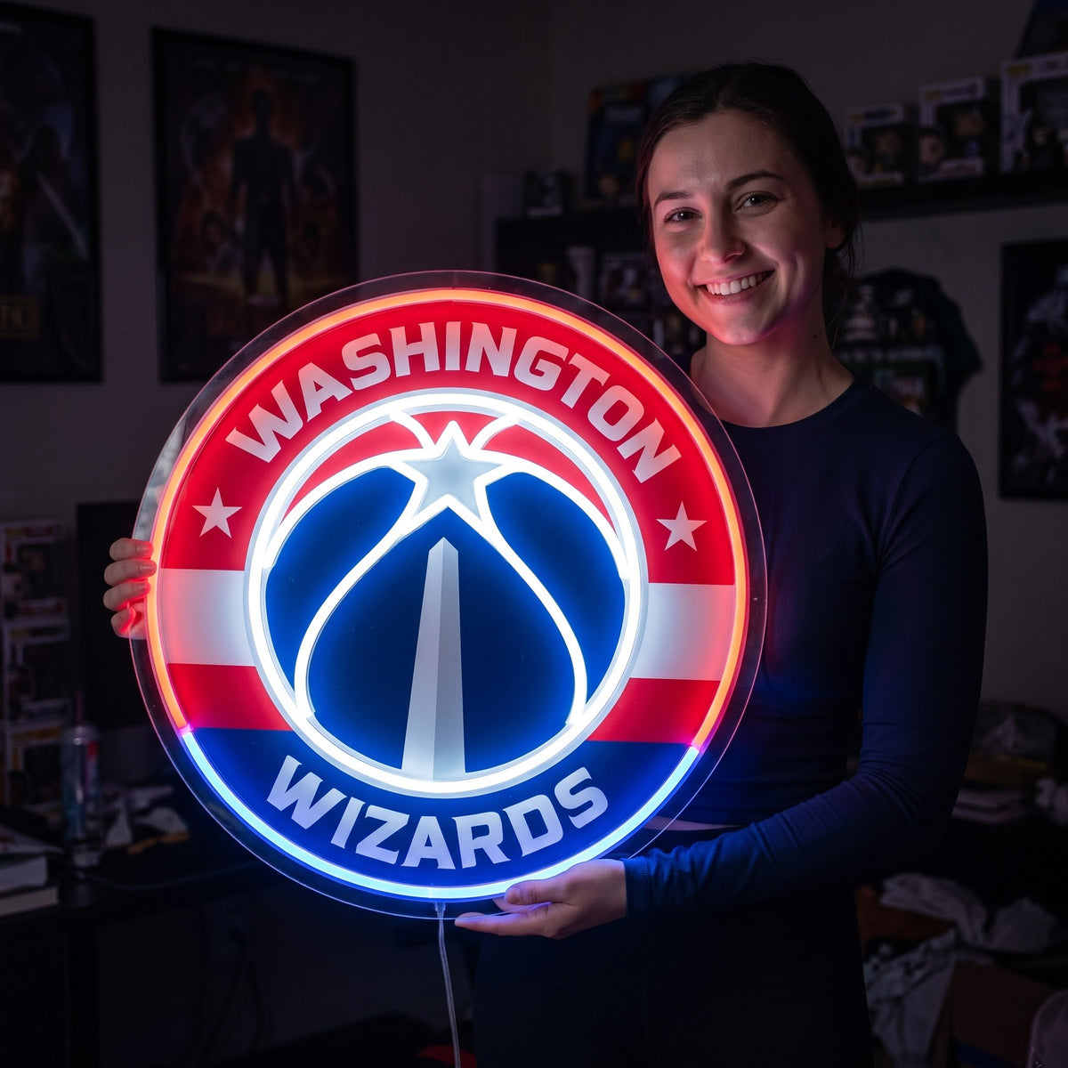 Woman holding a glowing Washington Wizards LED neon sign